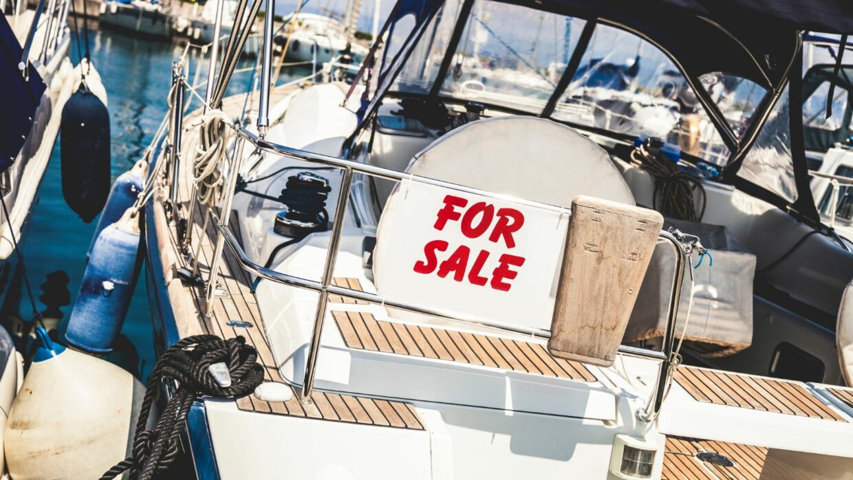 a boat with a "for sale" sign